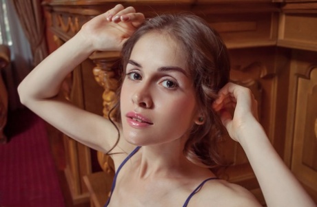 Petite teen girl uncovers her tiny tits as she removes her lingerie and undies