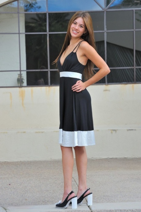 Naughty teen girl hikes up her dress in public and spreads her pink snatch