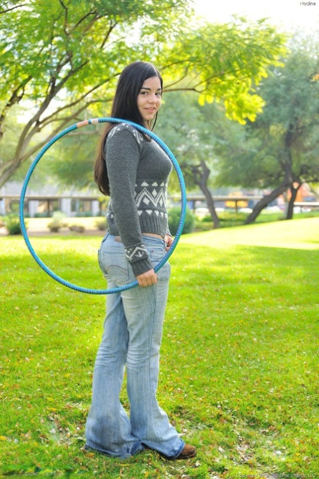 Chubby brunette takes off all her clothes in public while working a hula hoop