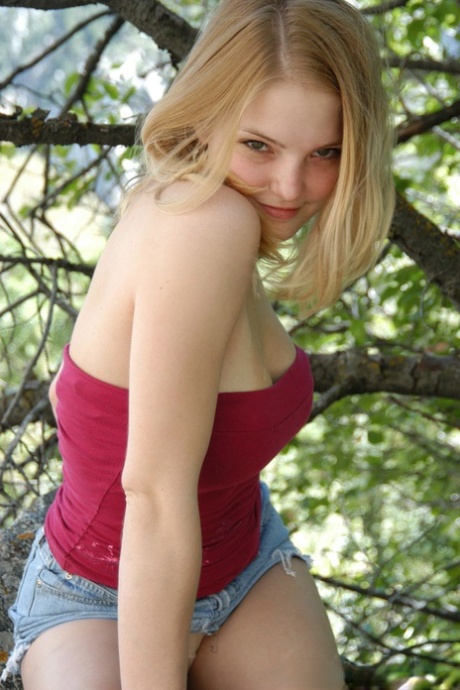 Young solo girl flashes her upskirt panties while climbing a rock