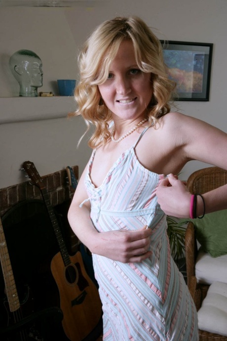 Skinny blonde teen Kimber Clarkson finger spreads her pink pussy