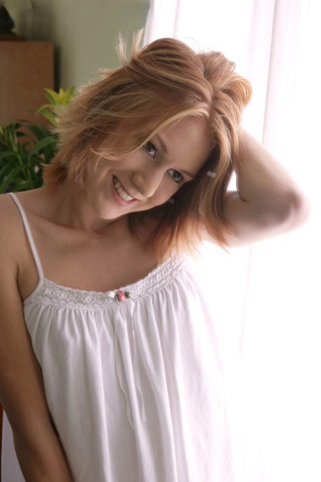 Skinny redheaded teen Alex Venice creams her pussy while getting naked
