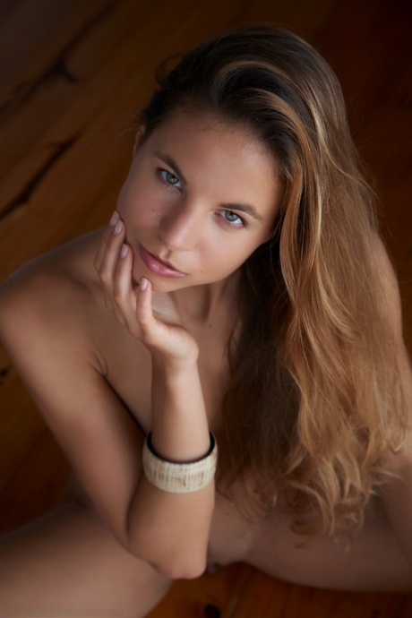 Totally naked teen Antea casts alluring looks during a solo shoot on a floor