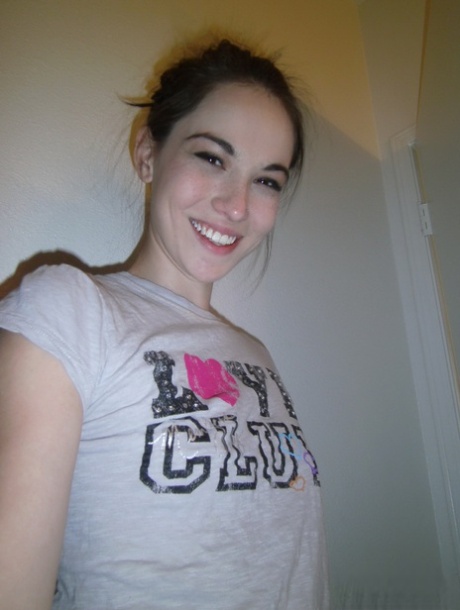 Cute brunette Emily undressing to take self shots of her bare tits and hot ass