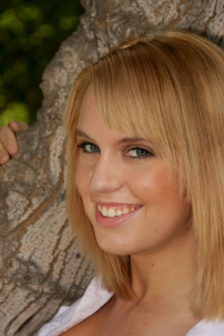Cute blonde Jessika sets her pudgy body free of clothes on a garden bench