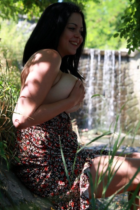 Big titted Latina girl Katarina takes off her dress to go nude on a riverbank