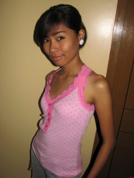 Slim 18 year old Asian girl shows her hairless pussy after a striptease