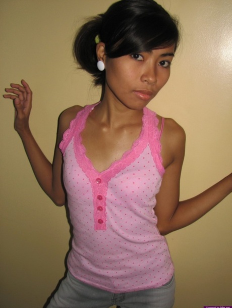 Slim 18 year old Asian girl shows her hairless pussy after a striptease