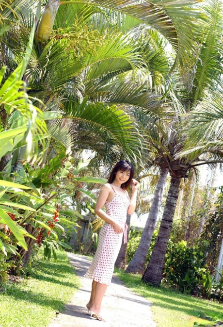 Young looking Japanese girl Saki Ninomiya gets naked with ocean behind her