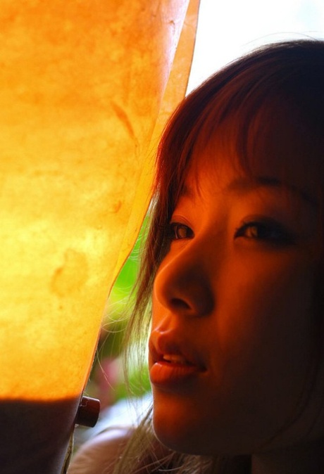 Japanese teen Yua Aida takes off her bikini for a nude shoot on a patio