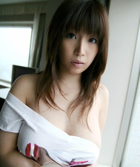 Pretty Japanese teen Haduki sets her beautiful boobs free during solo action