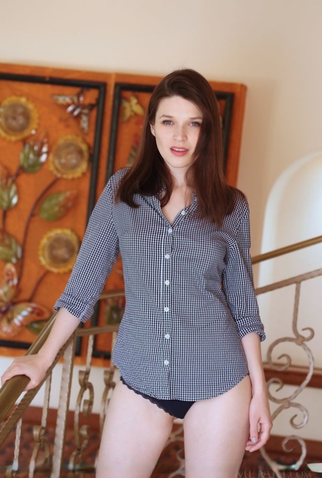 Caucasian teen Serena Wood cracks a smile after taking off all her clothing
