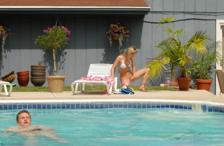 Sexy teen Kasia fingers her pussy by the pool with bikini top on