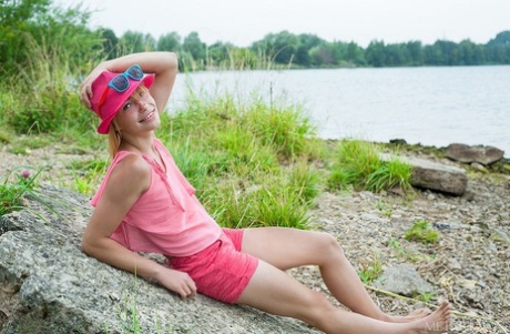 Petite redhead Shannan parts her pink teen pussy on a rocky shoreline
