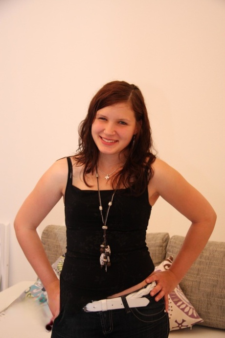 Young looking girl with pert titties makes her nude modelling debut on sofabed