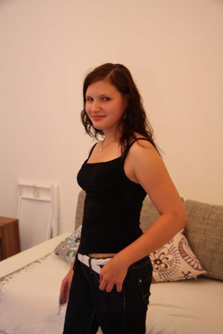 Young looking girl with pert titties makes her nude modelling debut on sofabed
