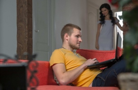 Slender teen Dinara seduces her man friend before they fuck on a sofa