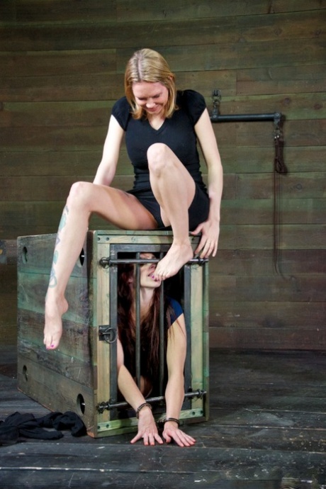 Teen pain sluts are kept in a cage until time for extreme bondage session