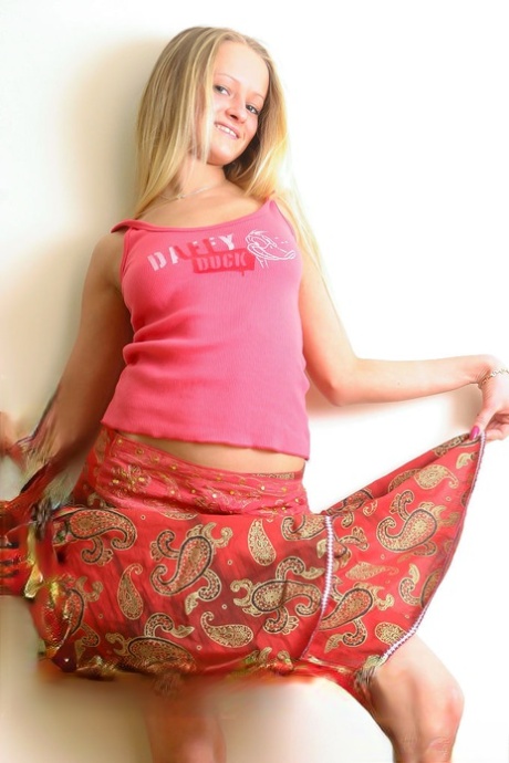 18-year-old blonde Marta A removes a skirt while getting naked in heels