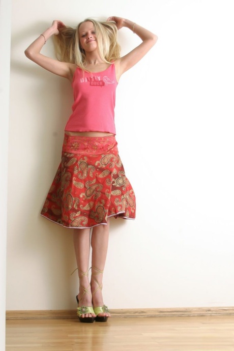 18-year-old blonde Marta A removes a skirt while getting naked in heels