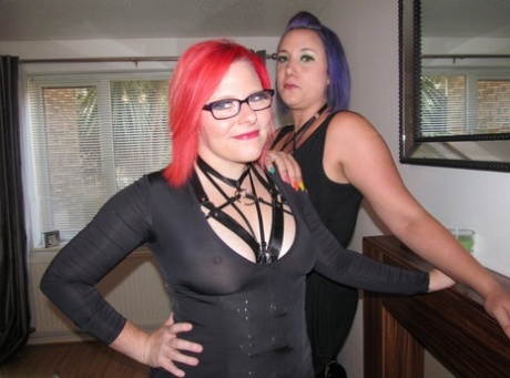 Amateur lesbians with dyed hair grind their pussies together on a sofa