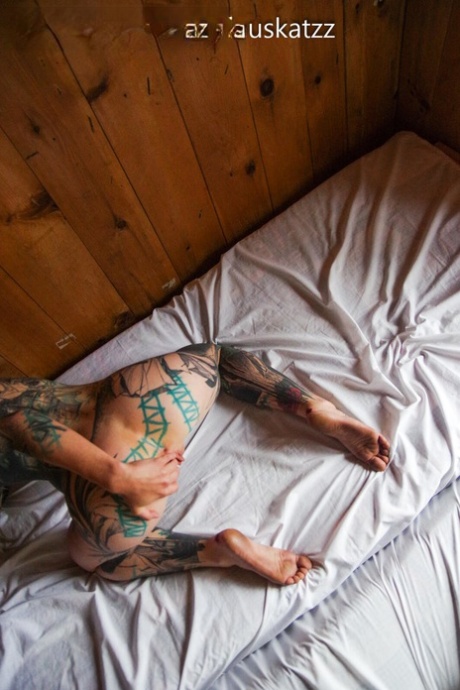 Heavily tattooed girl licks a penis while modelling in the nude