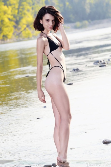 Petite teen Ohana splices in the water after removing her swimwear