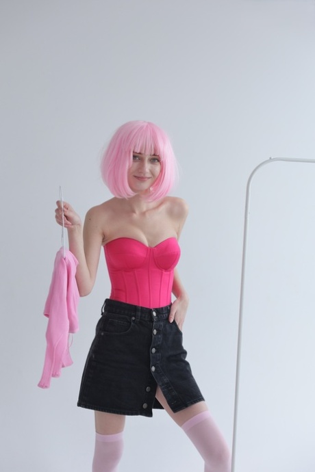 Cute teen with pink hair Atika gets completely naked on a sofa