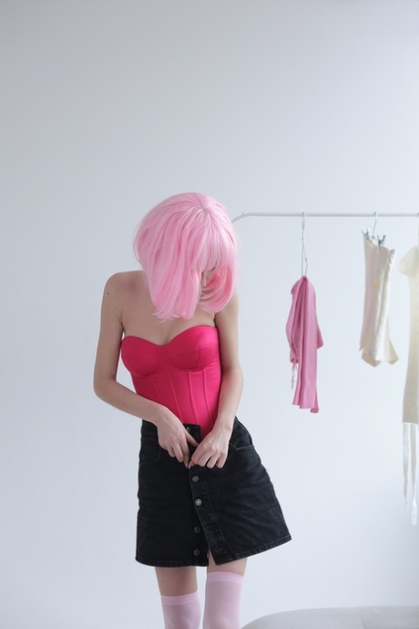 Cute teen with pink hair Atika gets completely naked on a sofa