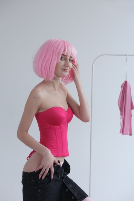 Cute teen with pink hair Atika gets completely naked on a sofa
