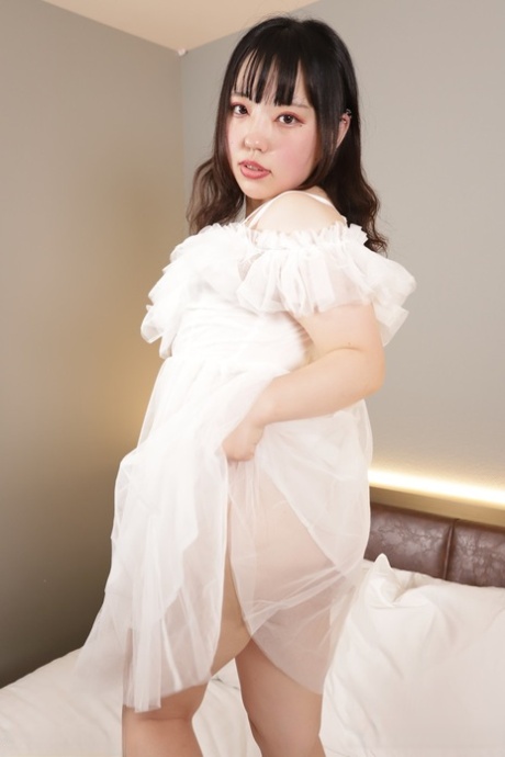 Japanese teen Sana Minami displays her juicy ass after going nude on a bed