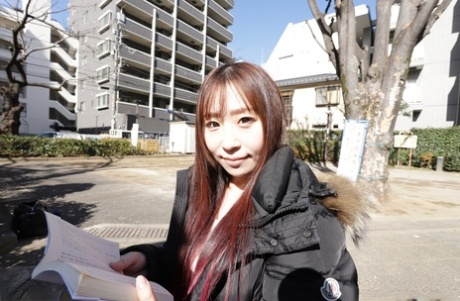 Japanese teen Ryo Ayase reads a book outdoors before going nude indoors