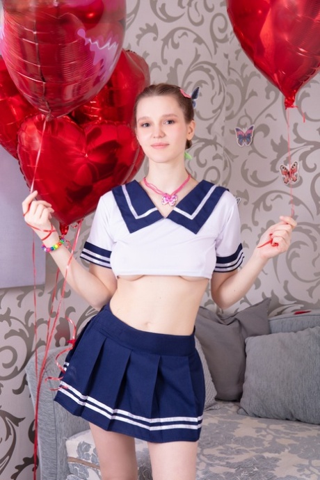 Adorable teen Miama holds balloons before stripping to her birthday suit