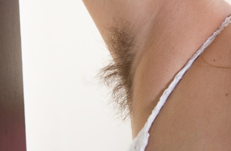 Cute teen Baby Lizza shows off her unshaven armpits and damp beaver