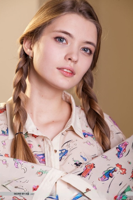 Blonde girl Sigrid in pigtails displaying her tiny tits and naked pussy