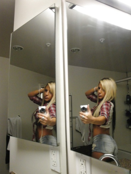 Perky blondie with piercing undressing and making selfies in the bath
