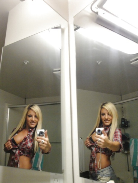 Perky blondie with piercing undressing and making selfies in the bath