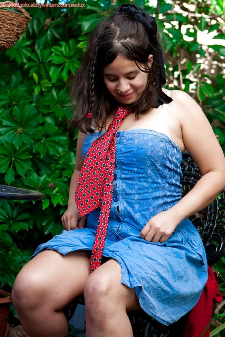 Young amateur girl Nikki S shows off her fat rolls after undressing outside