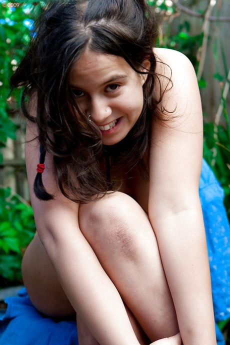 Young amateur girl Nikki S shows off her fat rolls after undressing outside