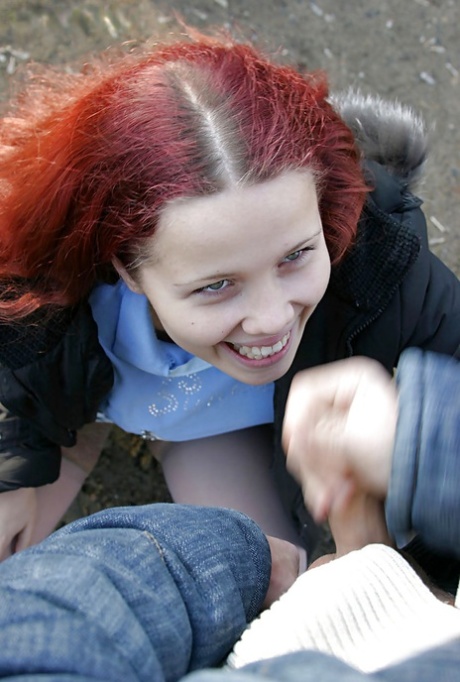 Redhead teenage lassie has some dirty fully clothed fun outdoor