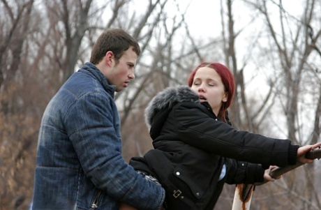 Redhead teenage lassie has some dirty fully clothed fun outdoor