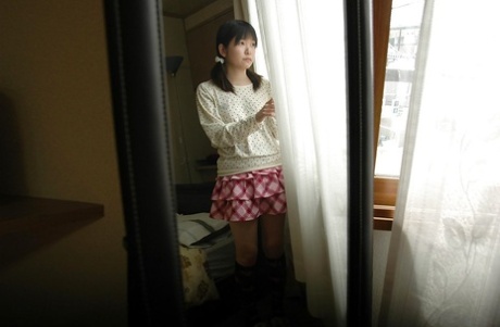Asian teen in knee socks taking off her panties and exposing her shaved gash