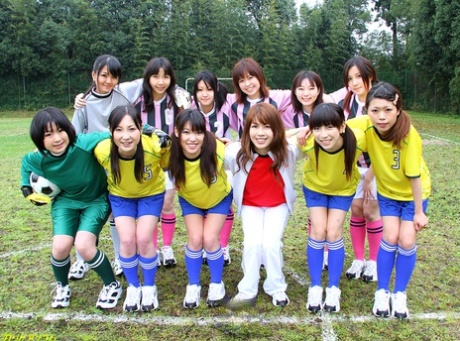 Asian female football team watches as a teammate gets fucked by the referees