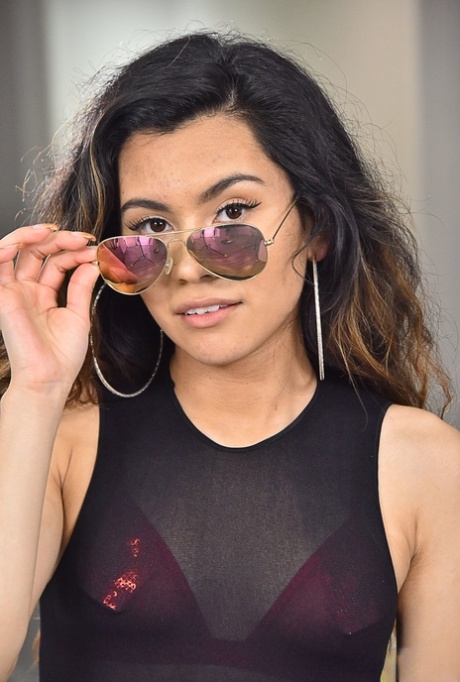 Exotic teen Christian Charity strips slowly and flaunts her sexy twat