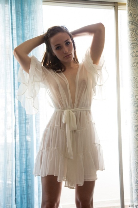 Amateur teen Diana Mackie poses in the window & in bed wearing a sheer robe