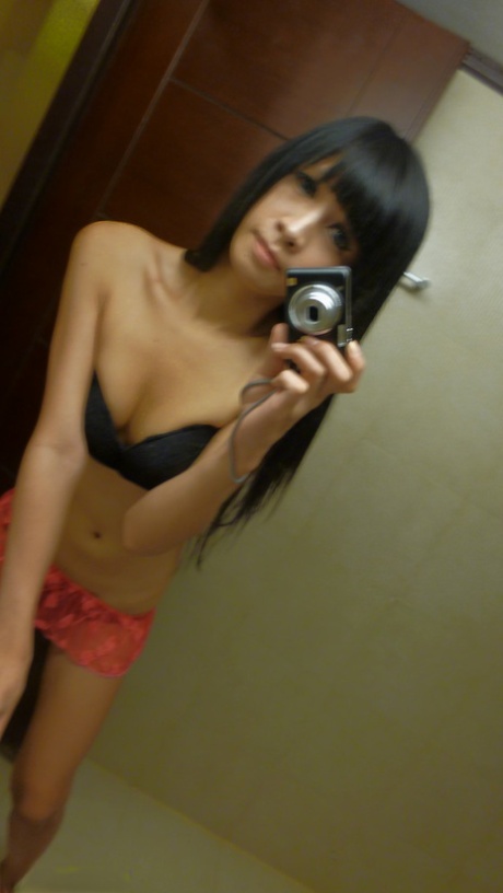 Skinny Asian ladyboys takes mirror selfies while getting undressed