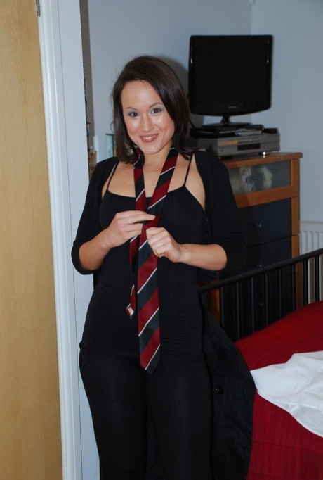 Naughty brunette with ponytails Lucy takes her school uniform for us
