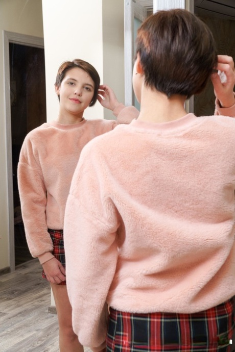Short haired teen Alex Swon reveals her bald cunt and rubs it in red socks
