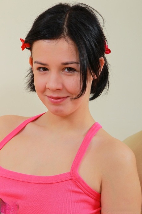 Teen with a hairy pussy Niky unveils her big tits and poses on a couch