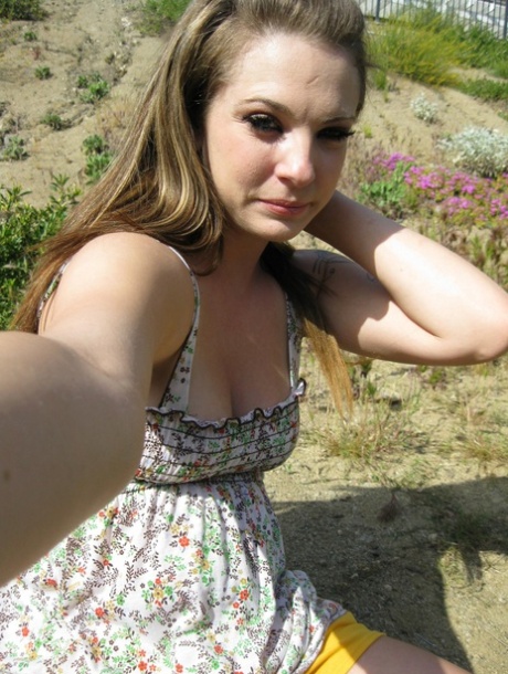Beautiful tattooed babe shows off her juicy natural tits outdoors